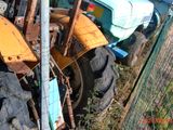 a tractor that is parked next to a fence