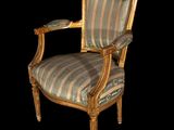 a chair that has a striped upholstered back and arms