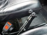 a close up of a car seat with a remote control in it