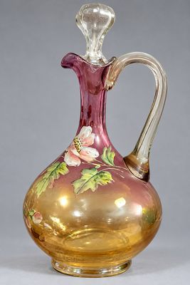 vase en verre violet et doré, orné de fleurs sur un fond gris
