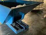 a close up of a blue dumpster in a warehouse
