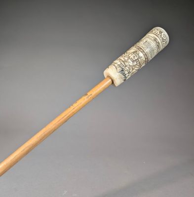 a wooden stick with a handle that has a design on it