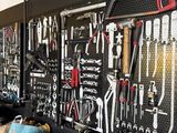 many tools hanging on the wall in the garage