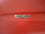 a close up of a red car with a number plate on it