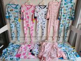 a lot of pajamas hanging on a rack in a room