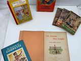 several children ' s books are sitting on a table with a white background