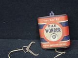 une boîte de « Pill Wonder » à côté d'une paire de pinces