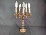 a gold candelab with five candles on it