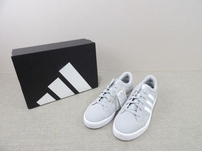 the adidas shoes are on the floor next to a box