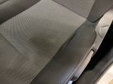 the interior of a car with a black leather seat and a gray seat cover