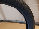 a tire that is sitting on the floor next to a cardboard box