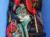 a blue bin filled with assorted tools in it