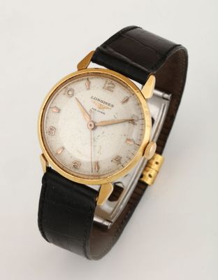 a close up of a watch on a white surface with a white background