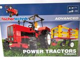 a box with a red tractor and a yellow trailer