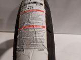 a close up of a tire on a white surface with a sticker on it