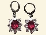 pair of ruby and diamond earrings on a white background