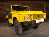 a yellow vehicle parked in a garage with a brick wall in the background