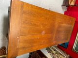 a wooden table with a wooden top in a room