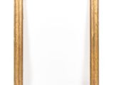 a gold frame on a white wall with a white background