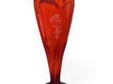 a red vase that is sitting on a white surface