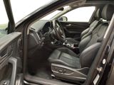 the interior of a car with the door open and the driver ' s seat down