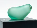 a glass figurine sitting on top of a black box