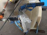 a blue hose attached to a white tank with a blue handle