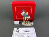 a close up of a figurine of a person with a red box