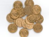 a pile of gold coins sitting on a white surface