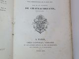 a book open on a table with a picture of a coat of arms on it