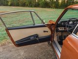 an old car with its door open on the side of the road
