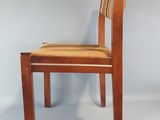 a wooden chair with a striped seat and back