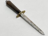 a knife that is laying on a white surface