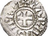 une pièce d'argent sur laquelle figure une croix au centre