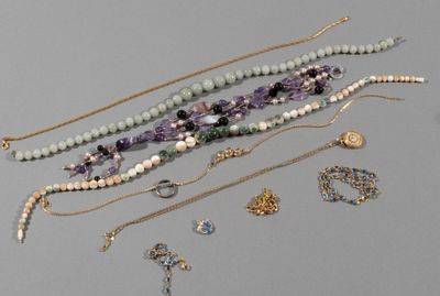 many necklaces and bracelets laid out on a table