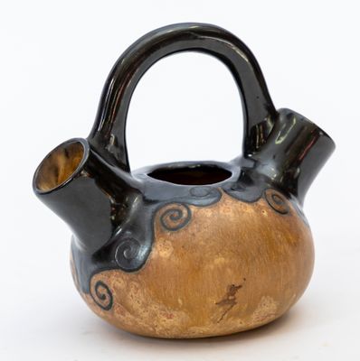 a black and gold vase with a handle on a white background