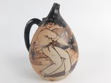 a vase with a picture of a man wrestling a woman