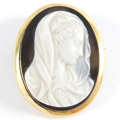 an image of a woman wearing a veil in a black and white cameo broochle