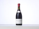 a bottle of red wine sitting on top of a table