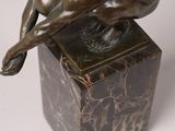 bronze sculpture of a dog on a marble base