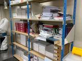 a room with a lot of boxes and papers on the shelves