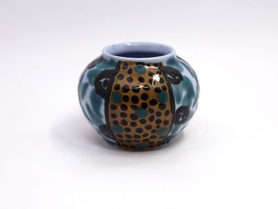 a blue and brown vase with a leopard print design on it