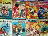 a lot of comic books on the table together