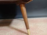 a small wooden table with two holes on it