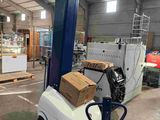 an image of a forklift with boxes on it in a warehouse