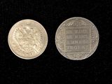 two silver coins are shown side by side on a black surface