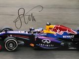 signed photo of a red bull racing car on a race track