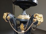 a black and gold pedestal with a gold lion on it