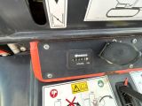 a close up of a car ' s dashboard with a warning sign on it