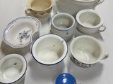 many bowls and cups sitting on the table together